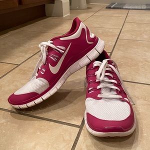 Women’s pink and white Nike Free Run